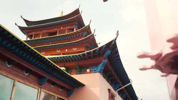 Zeitlupenvideo einer Drehung einer hölzernen rosa Trommel in der Nähe eines buddhistischen Tempels — Stockvideo