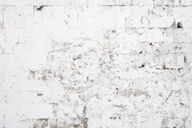 Beton bloklardan oluşan bir duvarın soyut arkaplanı şeffaf eski boyayla beyaza boyanmış.