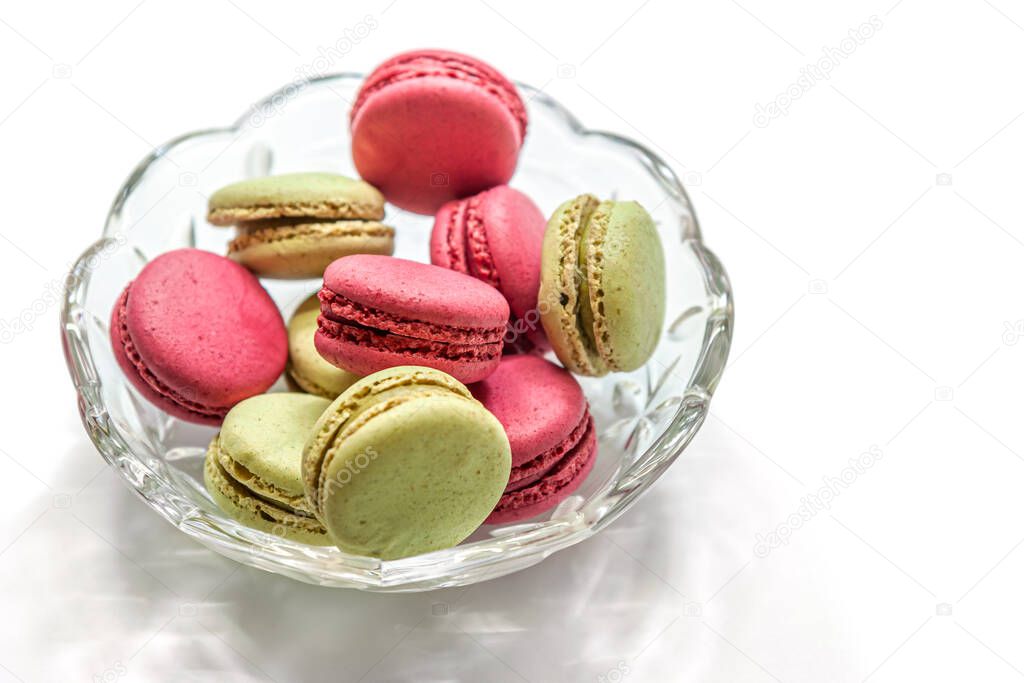 raspberry and pistachio macaroon cakes in a glass bowl isolated on white 