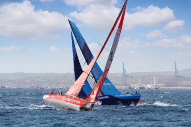 Two Teams  of OPEN 65 sailboats fighting moments after start Leg 1 Alicante-Lisbon of the Volvo Ocean Race 2017-18 one of the most exciting start we've seen from Alicante. clipart