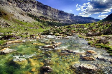 Mountains, waterfalls and watercourse in the top of the alpine zone of the National Park of Ordesa in the spanish Pyrenees. clipart