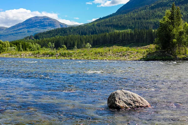 Flowing beautiful river lake Hemsila with mountain panorama in Hemsedal, Viken, Buskerud, Norway.