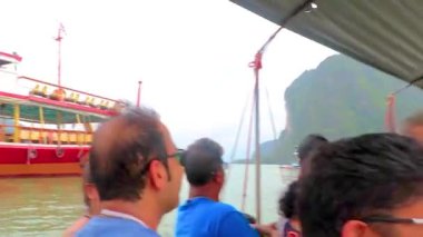 Takua Thung Phang Nga Thailand 12. June 2018 Tourists people on longtail long tail boat boats ship ships green water limestone rocks cliffs mountains at James Bond Island Khao Phing Kan in Thailand.