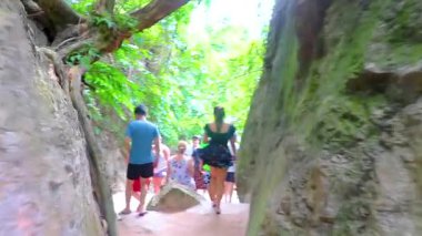 Takua Thung Phang Nga Thailand 12. June 2018 Walking between many tourist people souvenir shops store and limestone rocks on James Bond Island Khao Phing Kan in Krasom Phang Nga Thailand.
