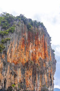 Takua Thung Phang Nga Province Thailand 12. June 2018 Ship boat and people in canoes kayaks at limestone cave in turquoise green water on Koh Ko Hong Island in Krasom Phang Nga Thailand.