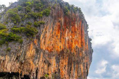 Takua Thung Phang Nga Province Thailand 12. June 2018 Ship boat and people in canoes kayaks at limestone cave in turquoise green water on Koh Ko Hong Island in Krasom Phang Nga Thailand.