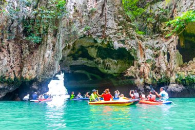Takua Thung Phang Nga Province Thailand 12. June 2018 Canoe canoes kayak kayaks travel through limestone caves in turquoise green water on Koh Ko Hong Island in Krasom Phang Nga Thailand.