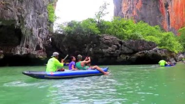 Takua Thung Phang Nga Province Thailand 12. June 2018 Canoe canoes kayak kayaks travel through limestone caves in turquoise green water on Koh Ko Hong Island in Krasom Phang Nga Thailand.