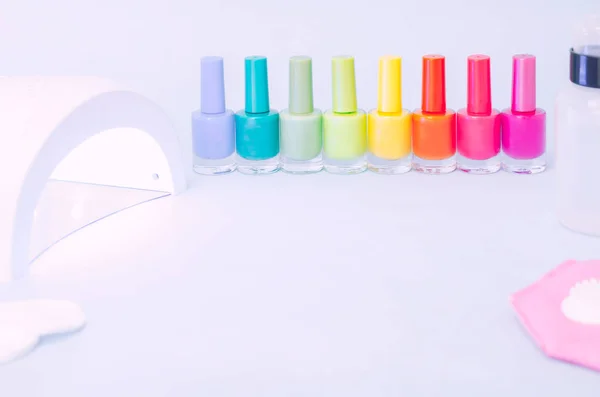 colored bubbles with varnish on an insulated surface with LED lamp for nail extension