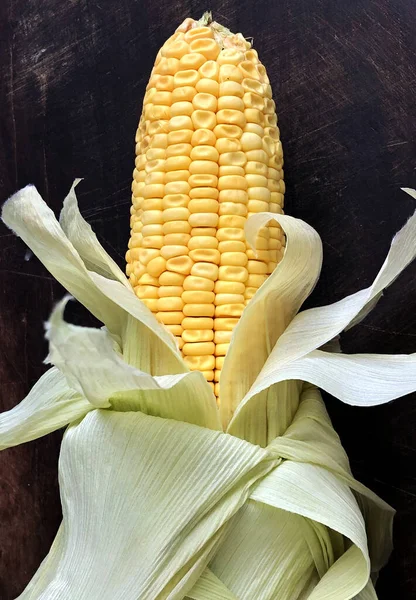 Corn maize with cereal grains and leaves. Sweet corn kept for cooking. Corn on the cob.