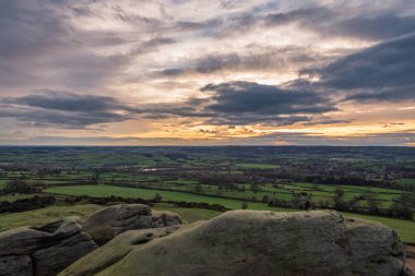 İngiltere 'de bulutlu bir günde gün batımında İngiliz tarlalarına tepeden bakan Almscliffe Crag, Uk.
