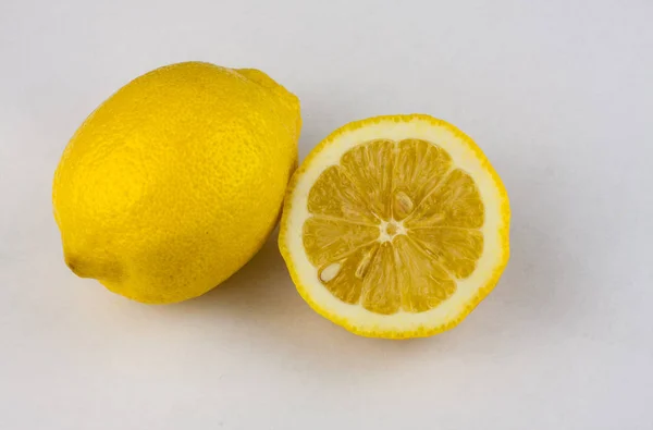 A whole lemon and half of it. Royalty Free Stock Photos