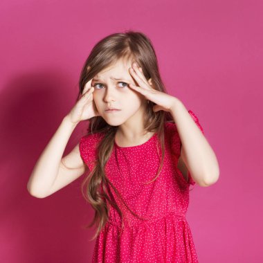 Küçük 8 yaşında kız elleri pembe tarafsız arka plan üzerinde bazı duygusal jest yapmak. O uzun esmer saç ve giyim kırmızı yazlık elbise vardır. Yüzünde komik ifade