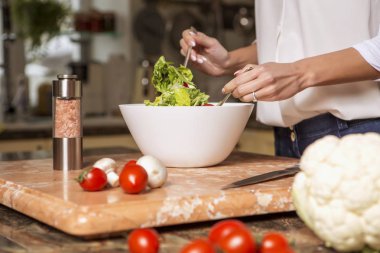 Gündelik kıyafeti evinde mutfakta yemek güzel genç esmer kadın. Lüks zengin iç