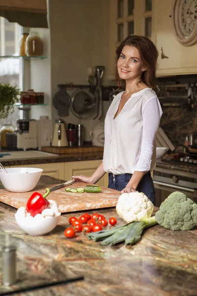 Gündelik kıyafeti evinde mutfakta yemek güzel genç esmer kadın. Lüks zengin iç