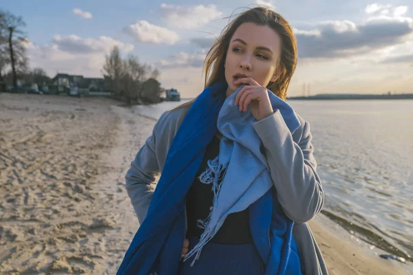 Gorgeous european woman in warm coat and dress on a walk in park