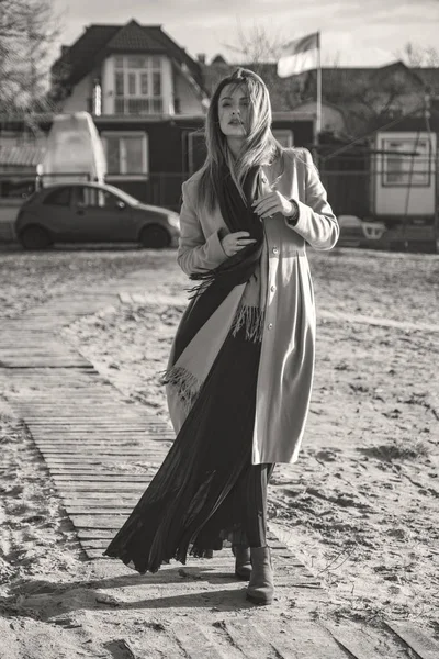 Gorgeous european woman in warm coat and dress on a walk in park