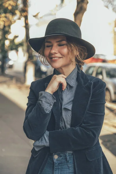 Elder adult caucasian woman on a walk in european street. Autumn