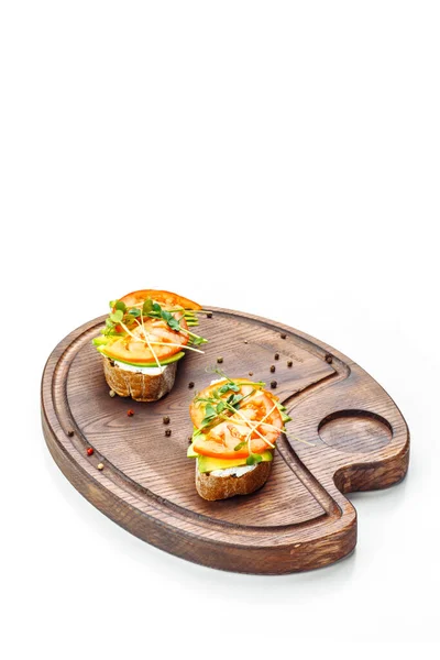 Bruschetta Tomato Cream Cheese Avocado Lies Wooden Board Isolated White — Stock Photo, Image