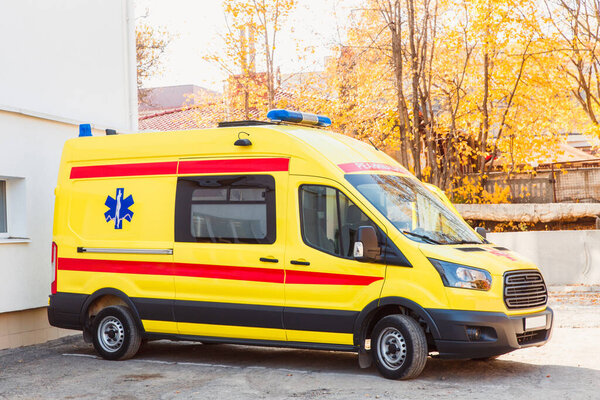 Zaporozhye/Ukraine- November 08 2019 :Yellow ambulance stands in the courtyard of the hospital: side view.