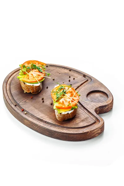 Bruschetta Tomato Cream Cheese Avocado Lies Wooden Board Isolated White — Stock Photo, Image