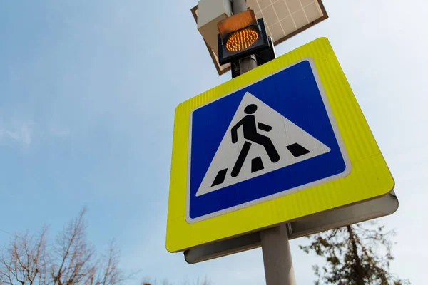 The pedestrian crossing sign powered by solar panels installed above. Traffic signs and rules.