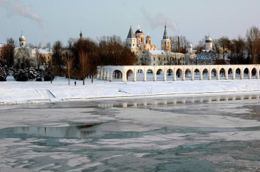 View of the ice-bound Volkhov river and Yaroslavovo dvorische, Veliky Novgorod. Russia clipart