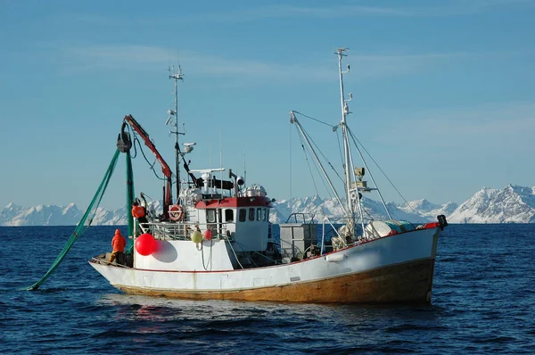 On a fishing boat catch fish: fishermen pull the trawl