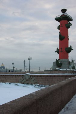 Rostral columns of Vasilievsky island on a cloudy winter day, St. Petersburg, Russia clipart