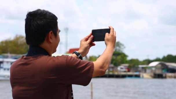 スマートフォンで海 港の風景を撮影する旅行者 — ストック動画