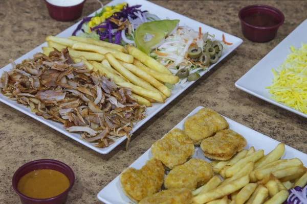 Typical dishes of the Middle East. Meat with potatoes and salad, plate of nuggets.