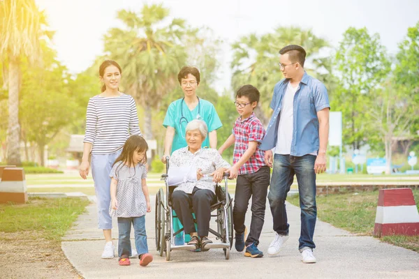 Senior Vrouwelijke Patiënt Zittend Rolstoel Met Haar Familie Verpleegkundige Ziekenhuis — Stockfoto