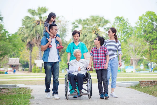 Senior Vrouwelijke Patiënt Zittend Rolstoel Met Haar Familie Verpleegkundige Ziekenhuis — Stockfoto