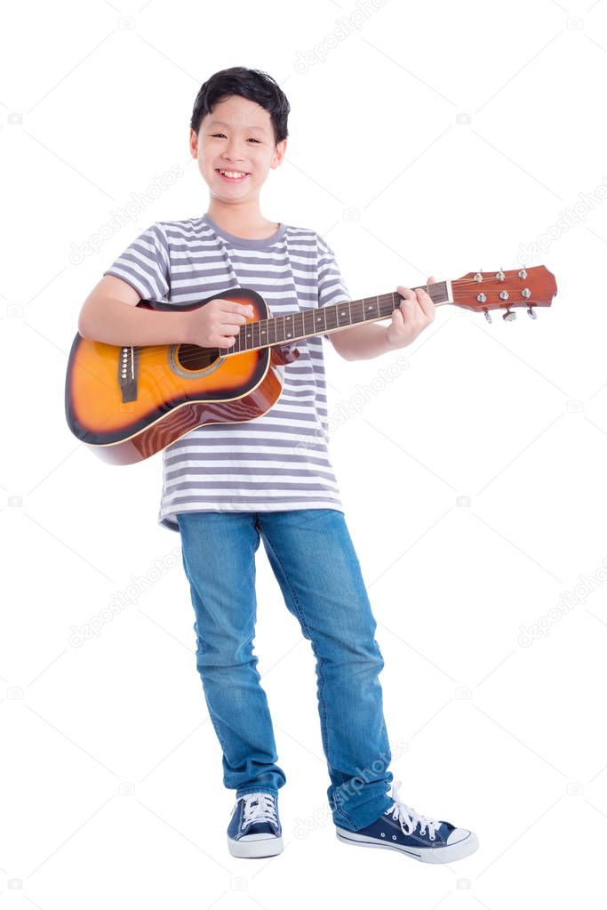 Full length of young asian boy playing guitar and smiles over white background