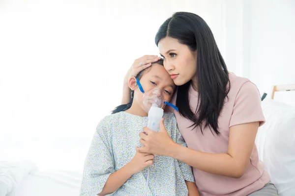 亚洲母亲在医院用氧气面罩安慰女儿 — 图库照片