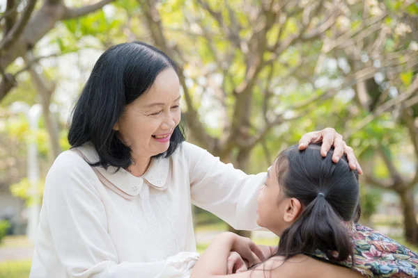 Asian Grandmother and granddaughter sitting together — Stock Photo, Image