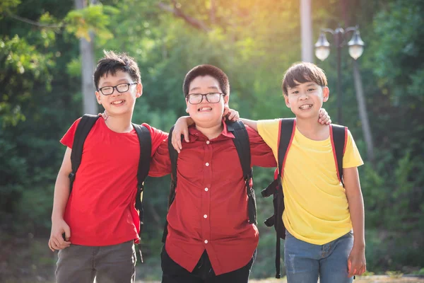 学校で一緒に立って微笑む3人の男子生徒 — ストック写真