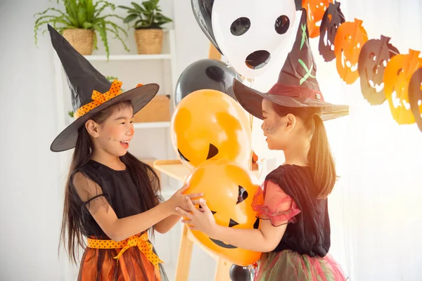 Two children in witch costume standing and playing together — Stock Photo, Image