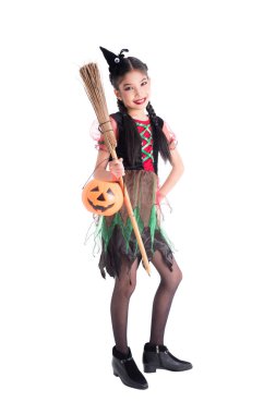 Full length of girl in witch costume holding bloom and halloween pumpkin bucket clipart