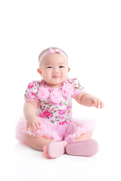 Full length of little baby girl in sweet pink dress sitting over white — Stock Photo, Image