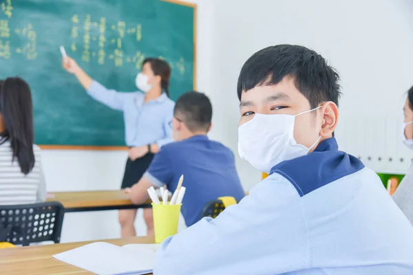 Yüz Maskesi Takan Asyalı Genç Bir Öğrenci Sınıf Arkadaşıyla Sınıfta — Stok fotoğraf