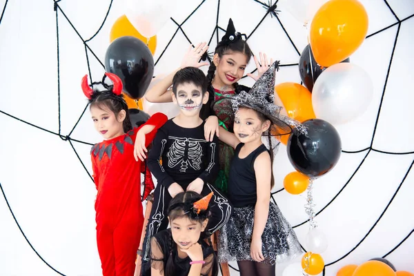 ハロウィンの衣装を着たアジアの子供たちのグループは 自宅でハロウィンパーティーを構成しています — ストック写真