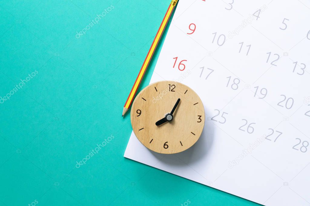 close up of calendar and clock on the green background, planning for business meeting or travel planning concept