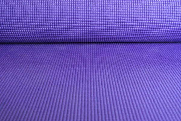 close up of yoga mat on the table, sport and healthy concept