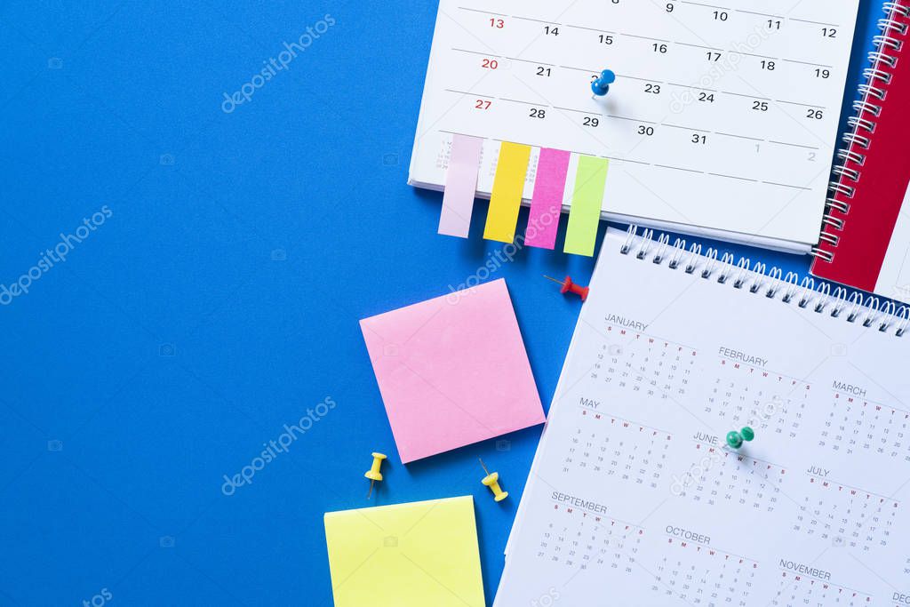 close up of calendar on the blue table, planning for business meeting or travel planning concept