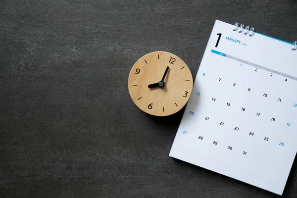 close up of calendar and clock on the table, planning for business meeting or travel planning concept