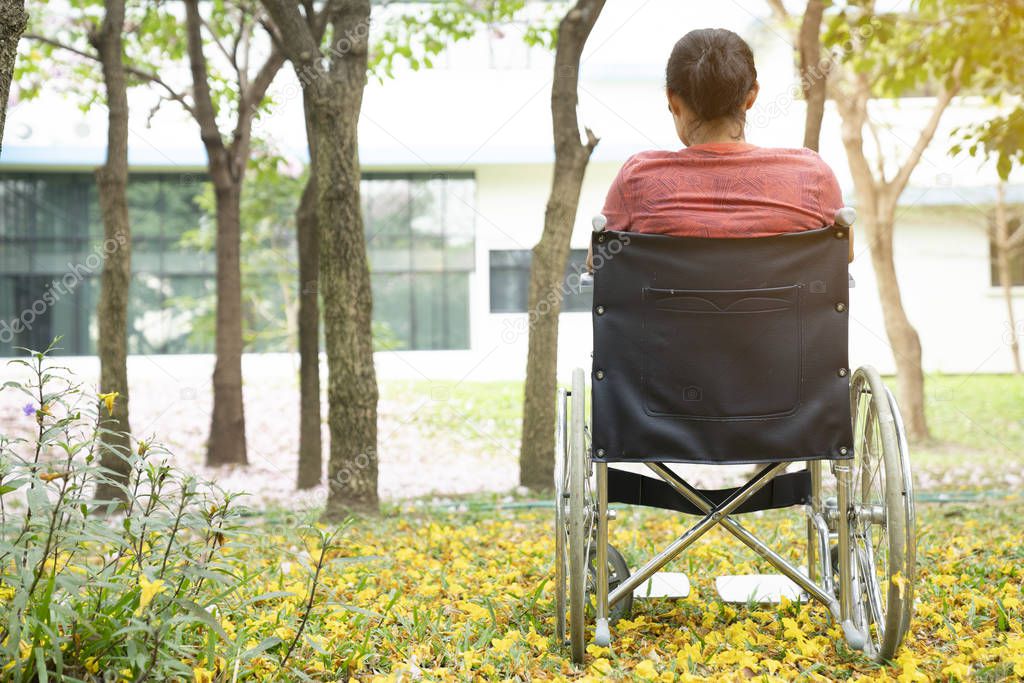 woman using a wheelchair in a park