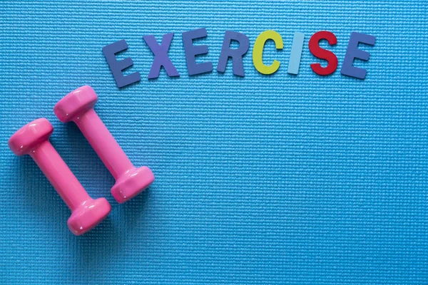 dumbbell and yoga mat on table, fitness healthy and sport concep