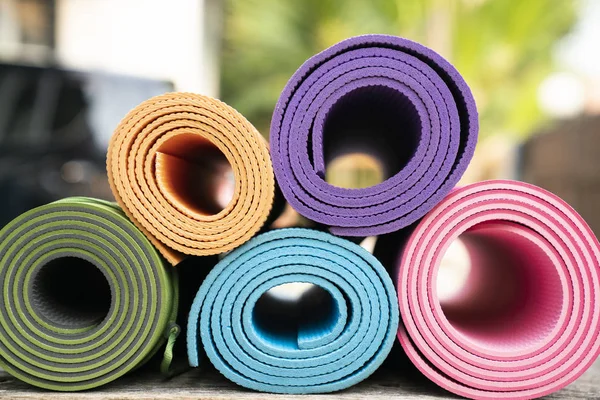 close up of colorful yoga mat on the table, sport and healthy co