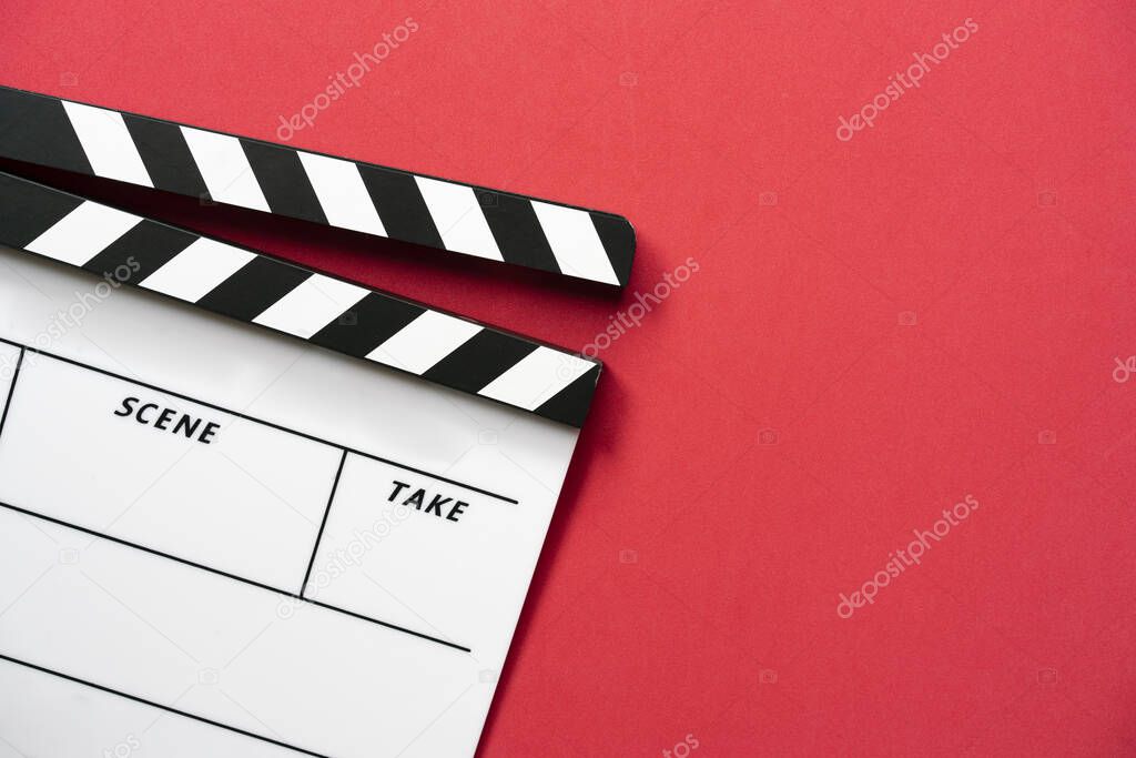 movie clapper on red table background ; film, cinema and video photography concept